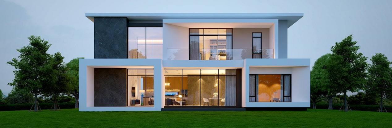 Modern home at dusk with interior lights turned on