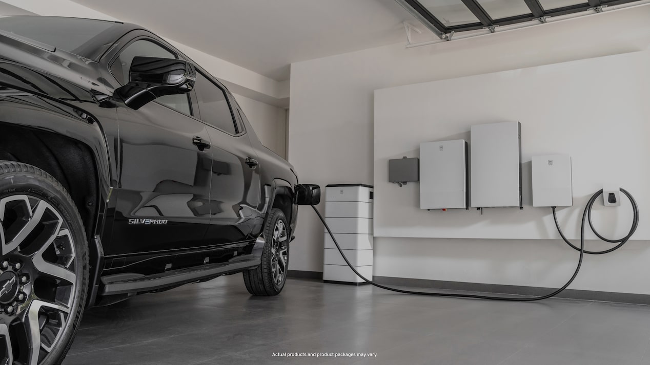 Black EV truck charging in garage